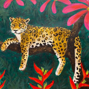 jaguar laying on branch